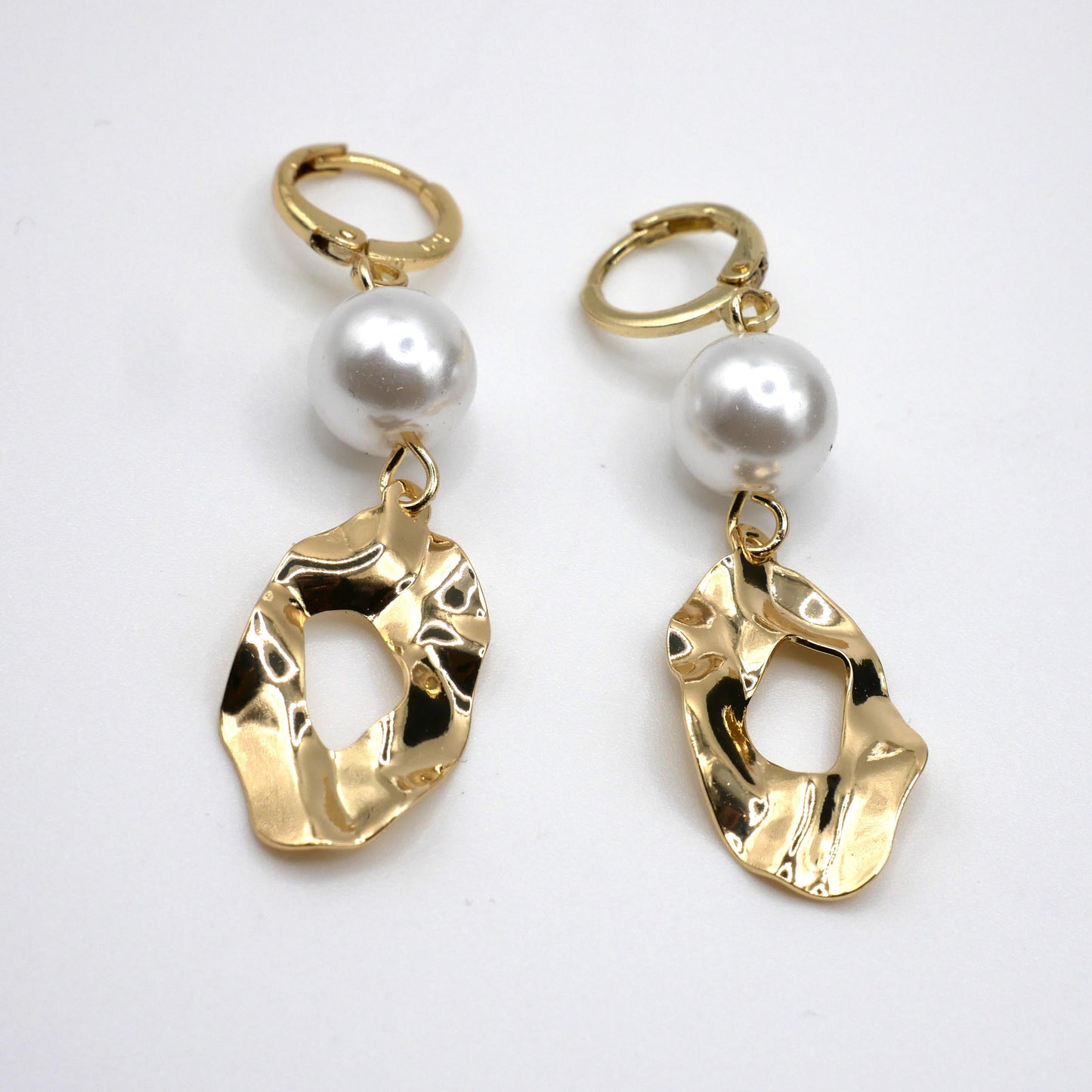 Gold Plated arrings with pearl drops on a white background
